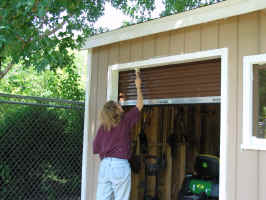 Cathy priming near roll-up door