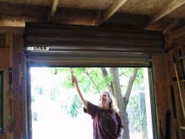 Cathy priming near roll-up door - Inside View
